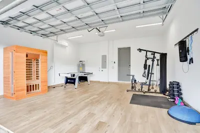 a gym with a bench and a table in a room at The Secret Garden - Stunning Luxurious Villa in Fort Lauderdale in Fort Lauderdale