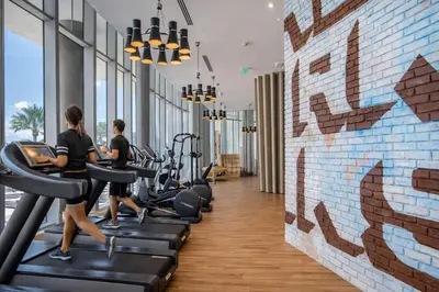 a gym with treadmills and people running on treadles at Ventur Luxe Condo l Oceanview - Gym, Beach Access in Hollywood