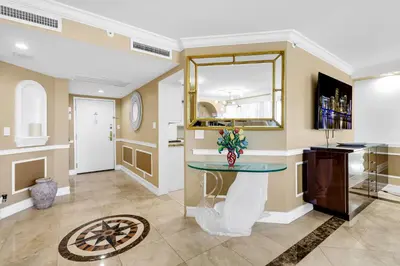 a room with a counter with a table and a mirror at Huge Beachfront 2400sqft 5 Bedroom 5 Bathroom with Ocean View in Miami Beach