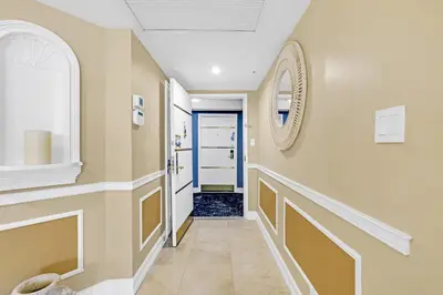 a hallway with a blue door and a window at Huge Beachfront 2400sqft 5 Bedroom 5 Bathroom with Ocean View in Miami Beach