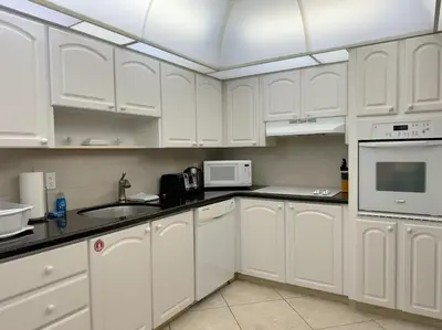 a white kitchen with white cabinets and appliances at Spectacular ocean view 1 bedroom in Hollywood in Hollywood