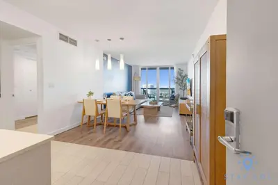 a kitchen and dining room with a table and chairs at Modern 1BR with Pool & Balcony in Hallandale Beach