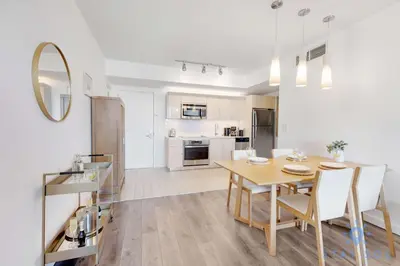 a kitchen and dining room with a table and chairs at Modern 1BR with Pool & Balcony in Hallandale Beach