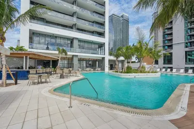 a swimming pool in front of a building at NEW Luxury Bay View Downtown Studio in Miami