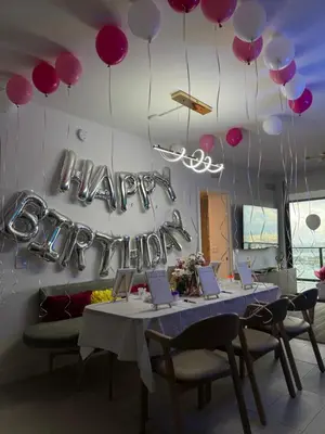a table with purple balloons and a sign that says happy birthday at NEW Luxury Bay View Downtown Studio in Miami