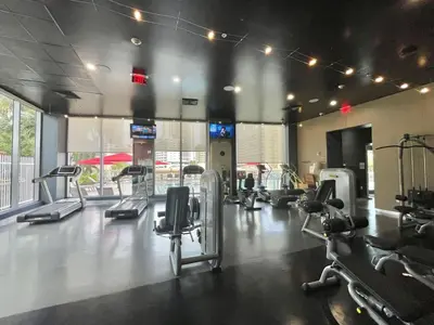 a gym with several treadms and cardio machines at 1 Bdm & Kitchen at Beachwalk Pool Gym Beach in Hallandale Beach