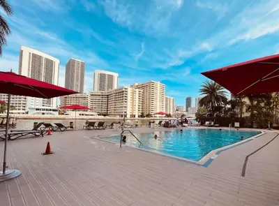 a swimming pool in the middle of a city with buildings at 2 Bed 2 Bath at Beachwalk with Luxury Pool and Gym in Hallandale Beach