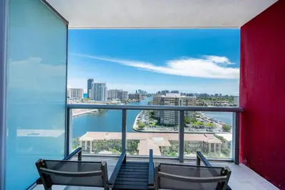 two chairs in a room with a view of the city at Modern 1BR w- Kitchen on 30th Floor Epic Views in Hallandale Beach