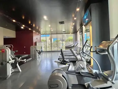 a gym with several cardio machines in a room at Stunning 30th-Floor Studio at Beachwalk Resort in Hallandale Beach