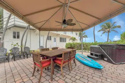 a table with chairs and an umbrella on a patio at Charming 2-BR space in Hollywood in Hollywood