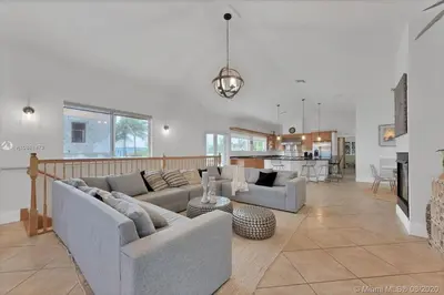 a living room with two couches and a kitchen at Oceanfront Villa On Semi-Private Holywood Beach in Hollywood