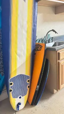 a surfboard sitting next to a kitchen sink at 3-BR space in charming Hollywood in Hollywood