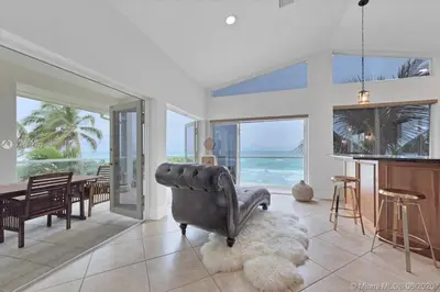 a living room with a couch and a dining room with the ocean at Gorgeous 4-bedroom beach space in Hollywood