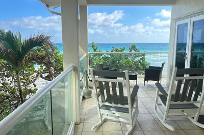 a balcony with chairs and a view of the ocean at Gorgeous 4-bedroom beach space in Hollywood