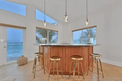 a kitchen with a island with bar stools at Gorgeous 4-bedroom beach space in Hollywood