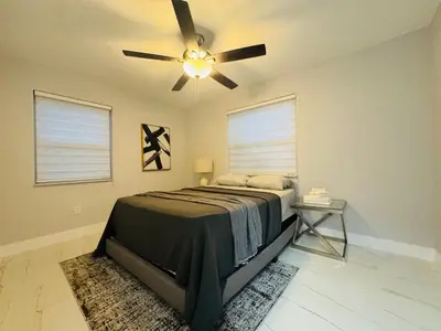 a bedroom with a bed and a ceiling fan at 5 Bedroom Home Location & Charm in Miami