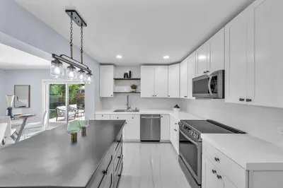 a kitchen with white cabinets and a counter top at 5 Bedroom Home Location & Charm in Miami