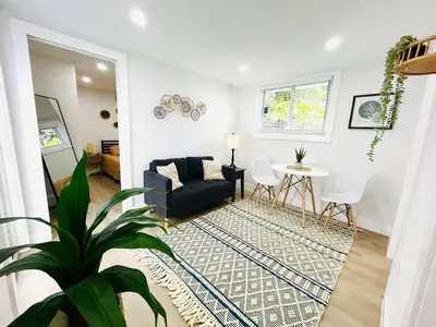 a living room with a black couch and a table at Chic Comfortable Boutique Stay in Miami