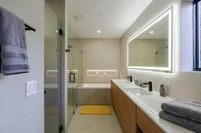 a bathroom with a sink and a tub and a mirror at Miami Oasis by Brickell and Beaches in Miami