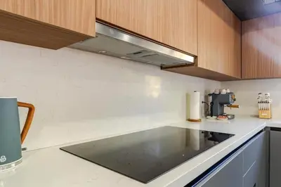 a kitchen with a counter with a stove top oven at Miami Oasis by Brickell and Beaches in Miami