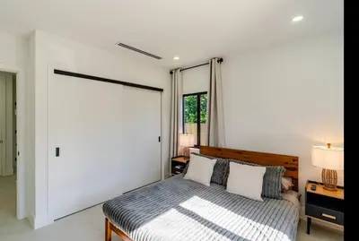 a bedroom with a bed and a large window at Miami Oasis by Brickell and Beaches in Miami
