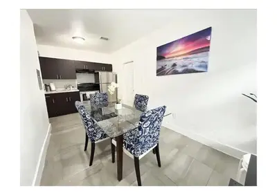 a dining room with a glass table and chairs at 2bed Stay in the Heart of Miami in Miami