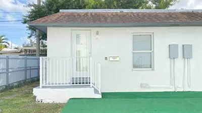 a small white house with a white door at 1Bed Abode Near Main Attractions in Miami