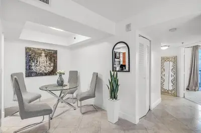 a dining room with a table and chairs and a mirror at Best views, 2 balconies, 2 bedrooms, pool, gym, parking in Miami