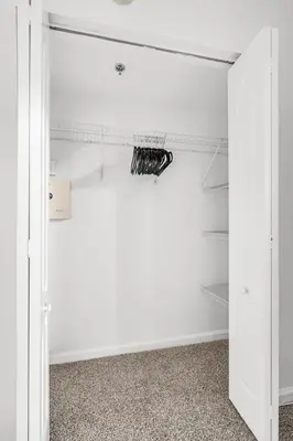 a walk in closet with white walls and shelves at Best views, 2 balconies, 2 bedrooms, pool, gym, parking in Miami