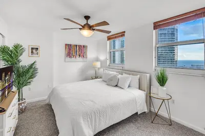 a white bedroom with a bed and a ceiling fan at Best views, 2 balconies, 2 bedrooms, pool, gym, parking in Miami