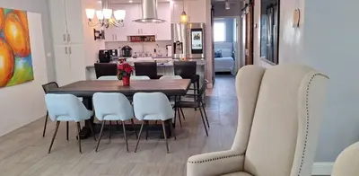 a dining room with a table and chairs at Luxury 3BR Duplex in Cutler Bay, Pool Table, BBQ, Terrace & Free Parking in Cutler Ridge