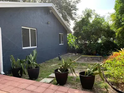 a blue house with plants in front of it at Known for its beaches & walk to downtown Hollywood Bliss 3 in Hollywood