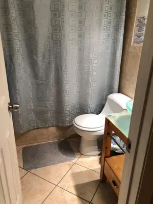 a bathroom with a toilet and a shower curtain at Known for its beaches & walk to downtown Hollywood Bliss 3 in Hollywood