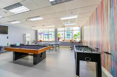 a billiard room with two tables and a pool table at Modern Brickell Condo with Prime City Views in Miami