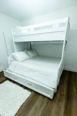 a white bunk bed in a room with a wooden floor at Your Perfect Oasis in Miami! in Miami