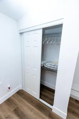 a closet with white doors and a wooden floor at Best Room in Miami ! in Miami