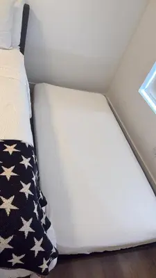 a small bed in a small room with a white mattress at Best Room in Miami ! in Miami
