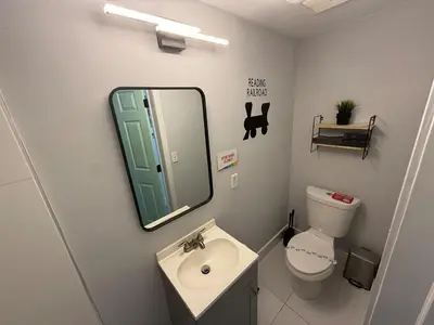 a bathroom with a sink and a mirror and a toilet at Prime Location Near Wynwood in Miami