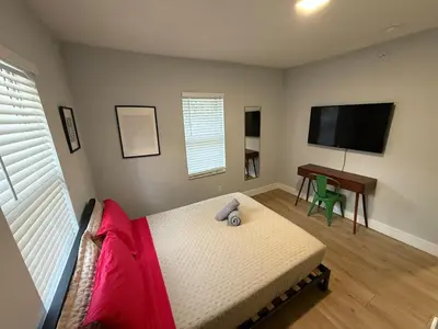 a bedroom with a bed and a flat screen tv at Prime Location Near Wynwood in Miami