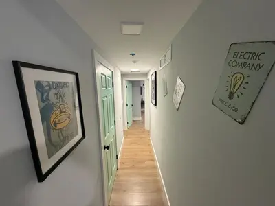 a hallway with posters and pictures on the walls at Prime Location Near Wynwood in Miami