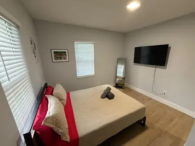 a bedroom with a bed with a teddy bear on it at Perfect Central Stay in Miami