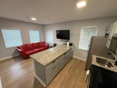 a kitchen with a red couch in a room at Perfect Central Stay in Miami