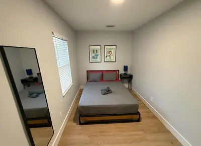 a small bedroom with a bed and a mirror at Stay Near Wynwood in Miami