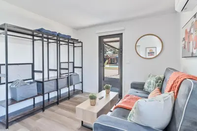 a living room with bunk beds and a couch at Near Beach Family Escape Heated Pool Fire Pit BBQ in Hallandale Beach