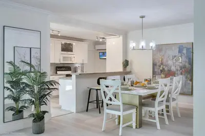 a kitchen and dining room with a table and chairs at Tropical 3BR Escape with Pool, 7 Min Drive to Beach in Hollywood