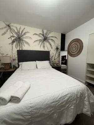 a bedroom with a white bed with two towels on it at Hotel Rainbow - Miami - Little Havanna in Miami