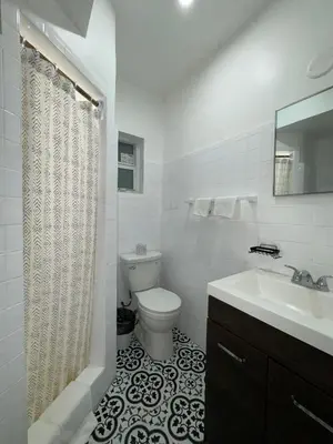 a white bathroom with a toilet and a sink at Hotel Rainbow - Miami - Little Havanna in Miami