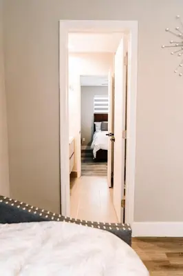 a bedroom with a white bed and a room with a bed sqor at Welcome to 305 Rentals in Miami Gardens