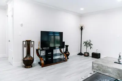 a living room with a flat screen tv on a stand at Welcome to 305 Rentals in Miami Gardens