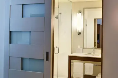 a bathroom with a shower and a sink at Four Points by Sheraton Coral Gables in Miami